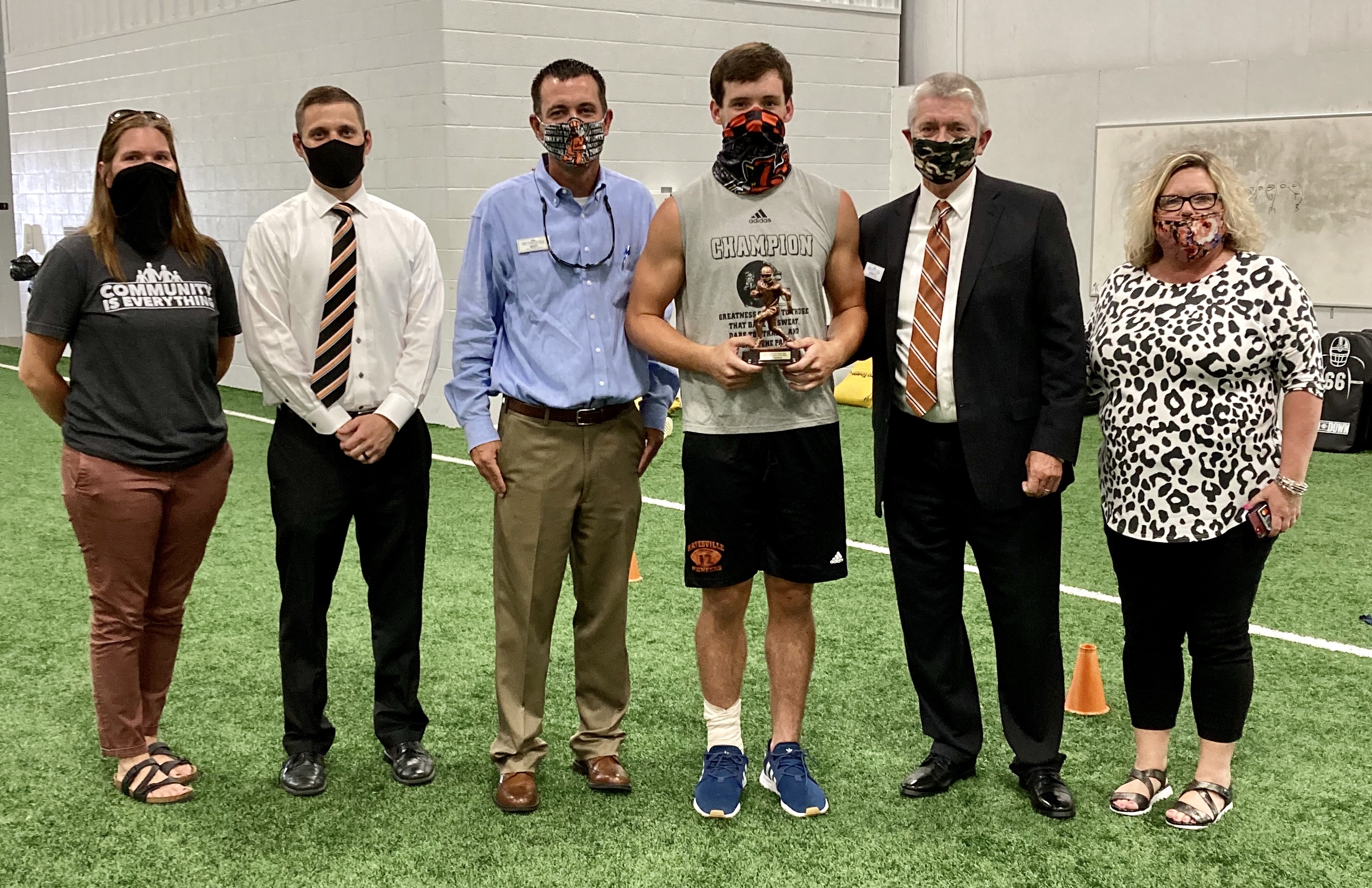 First Community Bank representatives Laura Brissey, Chris Milum, Matt McDonald, David Daniel and Lindy Hopper present Batesville QB Eli Livingston the FCB Scholar Athlete of the Week award