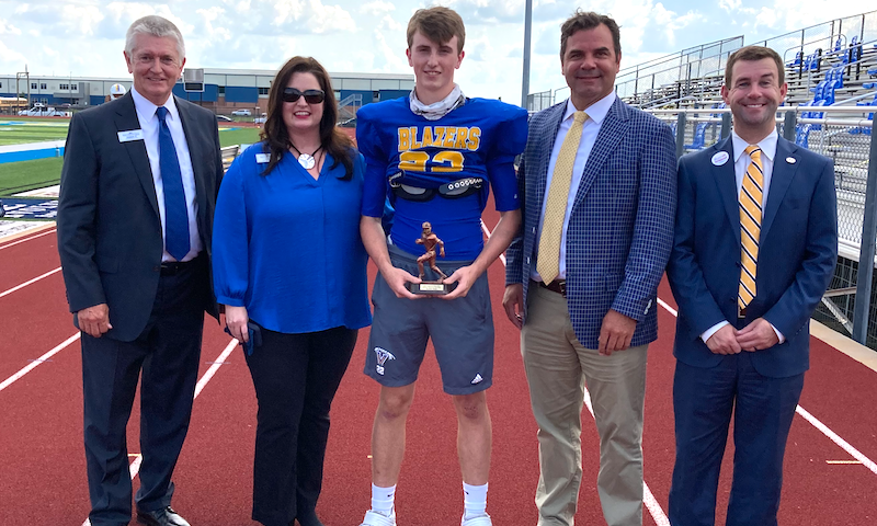 Valley View linebacker Kannon Jones receives the First Community Bank Scholar Athlete of the Week award from First Community Bank president Allen Williams and bank representatives David Daniel, Shena Sims and Brian Emison.